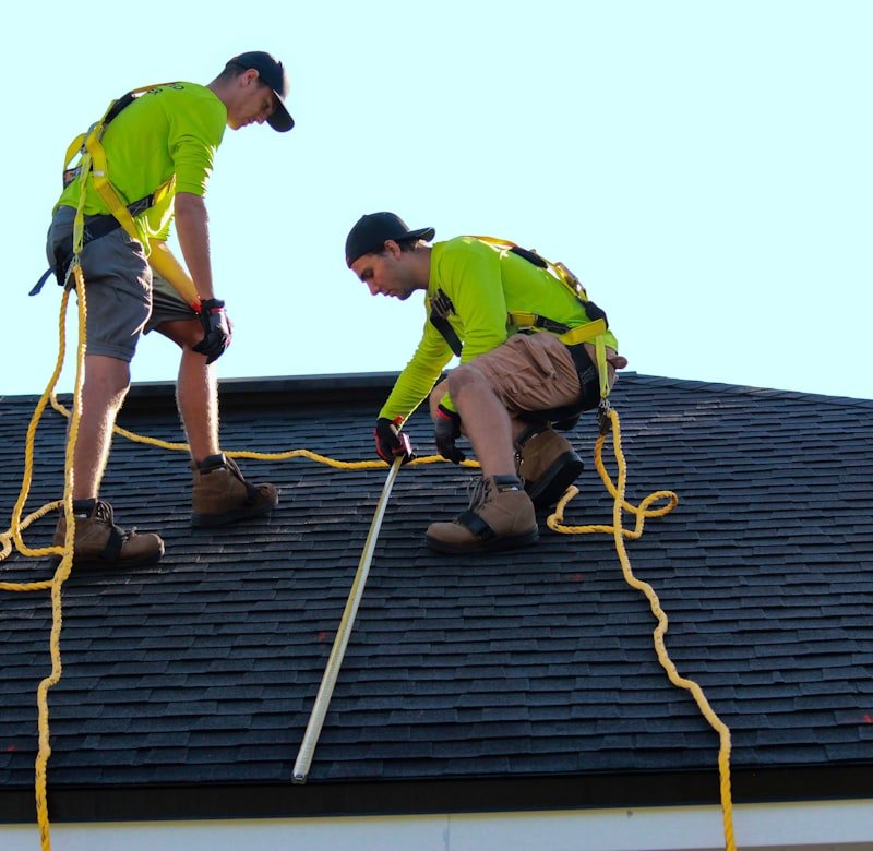 Roofers installing asphalt shingles